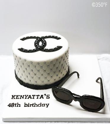 A custom Coco Chanel themed birthday cake complete with edible sunglasses made of sugar!