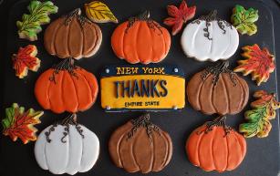 Pumpkins, fall leaves and a license plate that says Thanks make this custom decorated cookie set a lovely host gift for a Thanksgiving dinner party