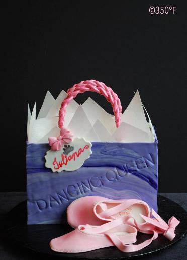 A birthday cake in the shape of a shopping bag for a ballerina