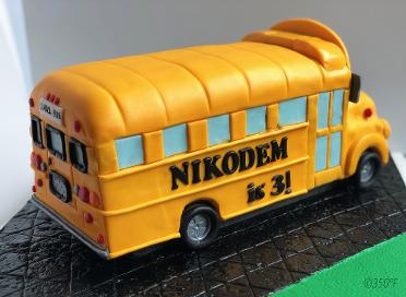 A sculpted, fondant, school bus cake for a little boy's 3rd birthday