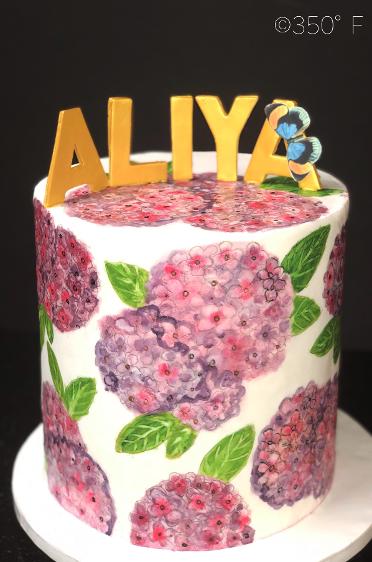 Queens, NY round tier cake with pink and purple flowers and gold letters