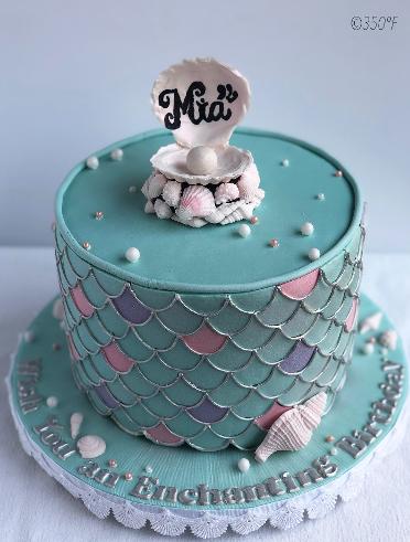 A mermaid themed fondant cake with chocolate shells and pearls for a little mermaid's birthday.