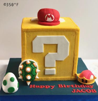 super mario birthday cake with mario cap, pricess crown, the egg and the shell of Bowser