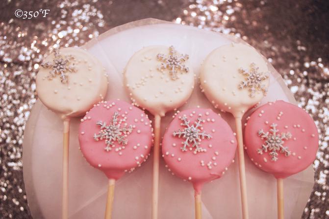 Dainty snowflake cake pops looking lovely on a Winter Wonderland dessert table at a Sweet 16 celebration