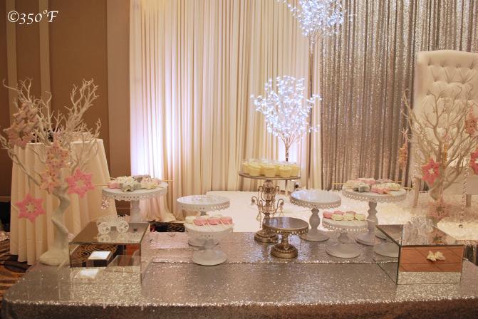 White and silver Winter Wonderland Sweet 16 themed dessert table with snowflake cookie trees and cupcakes by 350 Degree Fahrenheit