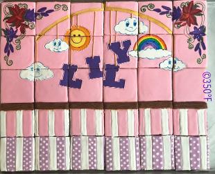 cookie puzzle for a baby's naming ceremony with a crib and music mobile scene