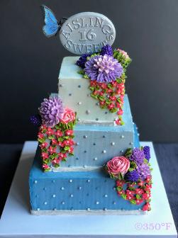 A floral buttercream tiered cake and a handmade sugar topper for a sweet 16.