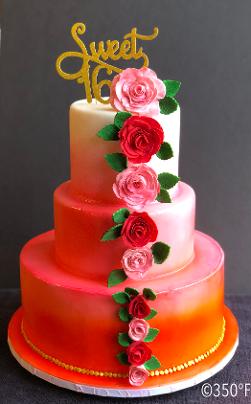 Pink and orange three tier round cake with flowers and 