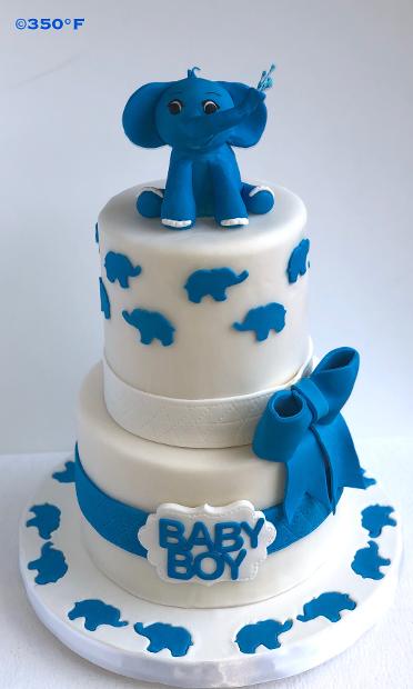 baby shower cake with a baby elephant topper made out of rice krispie treats