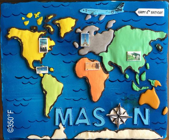 a world map hand-piped on a cupcake platter for a young jet setter