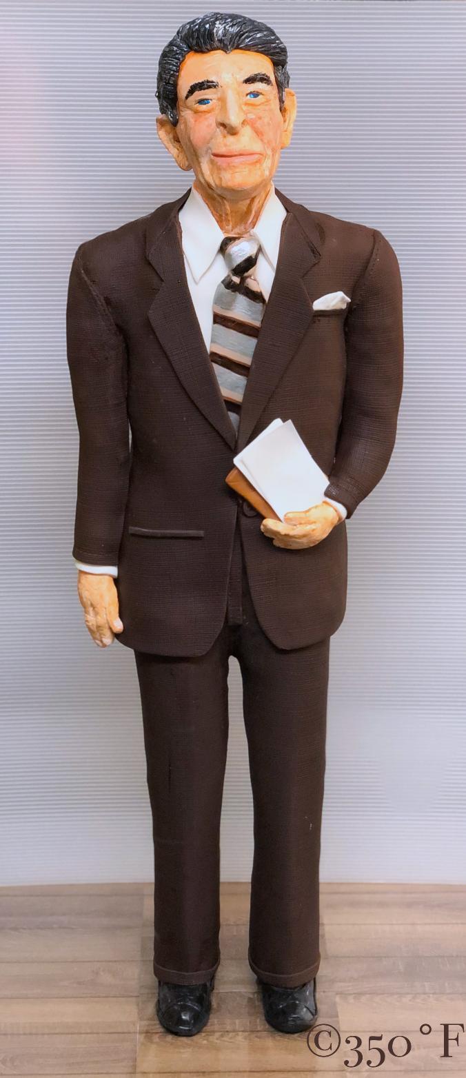 A sculpted cake of the standing figure of Ronald Reagan for a book launch event