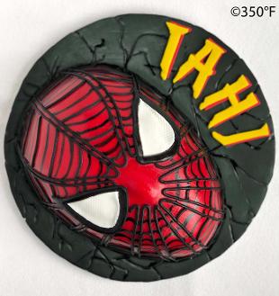 Black round cake with red spider-man mask in Queens, NY