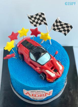 Red Ferrari rice krispie cake topper on a 2nd birthday cake