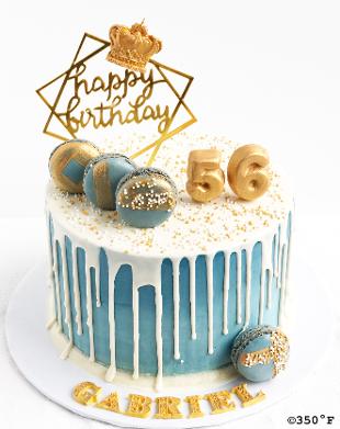 Blue, white, and gold round tier cake with 56 and macaroons