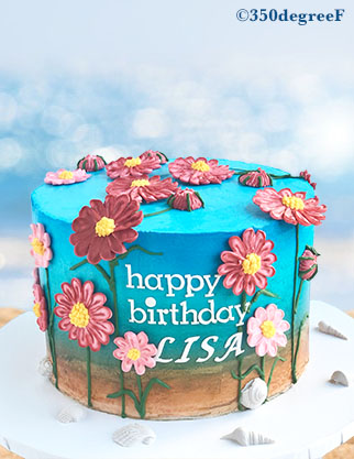 seascape birthday cake with royal icing flowers.