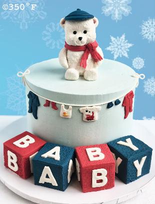 polar bear and baby blocks on a baby shower cake