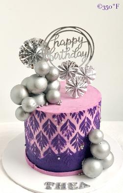 10th birthday cake for Thea with chocolate orbs painted with silver