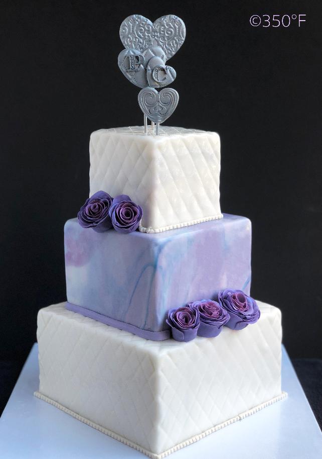 Lavender, white and silver wedding cake with marble effect and diamond weave pattern.